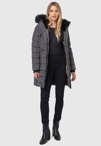 Gray padded parka with a faux fur-lined hood, zip front, and ribbed cuffs. Worn over a black top and paired with black pants and heeled boots.