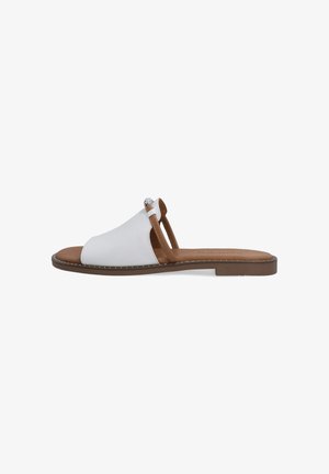 White slip-on sandals with a soft upper, brown sole, and decorative accents. Features open toe and two straps for support. Flat profile.
