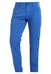 Modré bavlněné kalhoty slim fit, s předním zapínáním na knoflík, poutky na opasek a jemnou texturou. Žádné viditelné vzory ani akcenty.