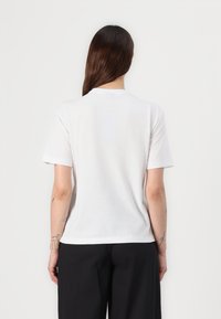 White short-sleeve T-shirt with a round neckline and a soft texture, featuring a plain design and no visible graphics or logos.