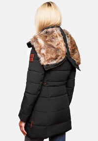 Black puffer jacket with faux fur collar, textured finish, zip closure, and brown accents on the collar and sleeve. Features side pockets.