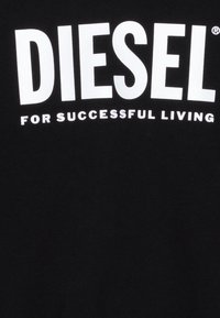 Black T-shirt with large white text "DIESEL" above smaller white text "FOR SUCCESSFUL LIVING," featuring a soft cotton fabric texture.