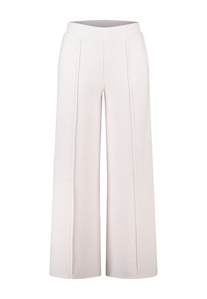 Brede, ribgebreide broeken in gebroken wit met een soepele tailleband. Bevat verticale naden voor extra textuur en structuur.