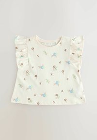 T-shirt kratkih rukava od svijetlosmeđeg pamuka. Ima cvjetni uzorak u plavoj i smeđoj boji, s volanastim naglascima na ramenima i okruglim izrezom.