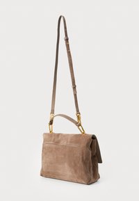 Brown suede handbag with a structured shape, featuring a top handle and adjustable strap, gold hardware accents, and a rear pocket.
