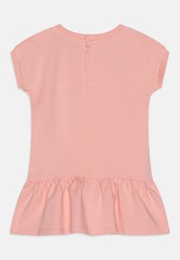 Růžové šaty s krátkými rukávy a volánkovým lemem, vyrobené z měkké bavlny. Mají kulatý výstřih a tři patentky na zadní straně.