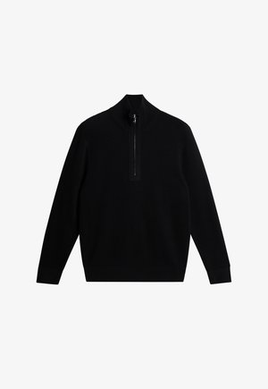 Schwarzer Pullover aus geripptem Stoff, mit hohem Kragen und kurzem Reißverschluss. Lange Ärmel mit enganliegenden Bündchen, schlichtes Design.