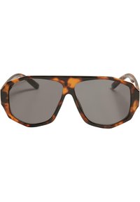 Lunettes de soleil en écaille de tortue avec un cadre géométrique octogonal et des verres gris foncé. Dotées de branches solides et d'une finition brillante.
