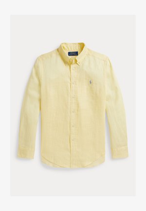 Sárga, hosszú ujjú, gombos ing, könnyű anyagból készült. Klasszikus gallérral, elöl végig gombokkal és a mellkason hímzett logóval rendelkezik.