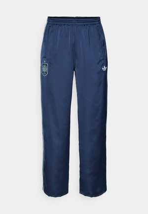 Tume sinine sportlikud püksid elastse vöökohaga, küljetaskud ja valge Adidas'i logo. Vasakul reiel on Hispaania vapp. Sile tekstuur.