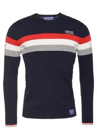 Tmavě modrý bavlněný svetr s dlouhými rukávy, s vodorovnými pruhy v červené, šedé a bílé barvě. Má na hrudi nášivku s logem.