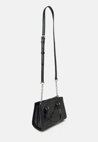 Black handbag with a textured, crocodile pattern. Features a structured shape, dual handles, and a detachable chain-accented strap.