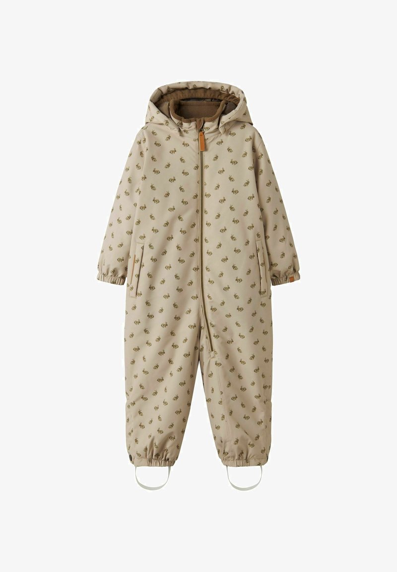 Bežs viengabala kombinzons ar kapuci, ar atkārtotu zaļu rakstu, elastīgām aprocēm un priekšējo rāvējslēdzēju. Piemērots āra lietošanai.