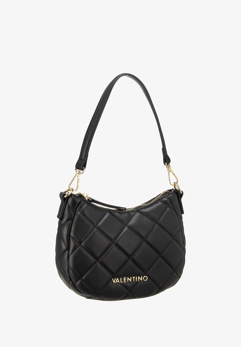 Black quilted leather handbag with a curved shape, gold hardware, and a logo at the front. Features a single shoulder strap.