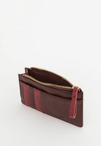 Burgundy leather wallet featuring a zippered compartment, exterior card slots with red accents, textured surface, and a wrist strap.
