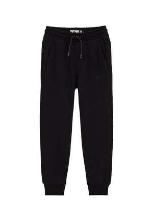Pantalon de jogging noir avec ceinture élastique, cordon de serrage, poches latérales, poignets côtelés et texte subtil "Salty Dog" sur la cuisse gauche.