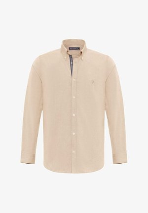 Beige langemouwen shirt van textuurstof, met een button-down kraag, witte knopen en een klein logo op de borst.