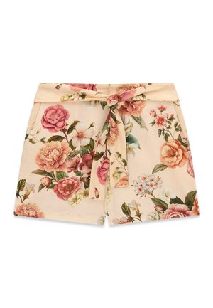 Short beige taille haute avec imprimé fleur rose et vert, avec une large ceinture et une ceinture en tissu nouée à l'avant.