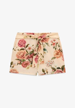Short beige a vita alta con stampa floreale rosa e verde, con fascia larga in vita e cintura di stoffa annodata davanti.