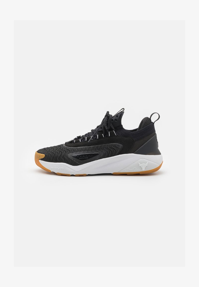 Black athletic shoe with textured synthetic upper, white sole, rubber outsole, and prominent branding on the heel. Laced design.