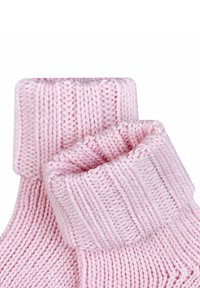 Pink knitted socks with a ribbed cuff, featuring a soft texture and an even pattern throughout. Designed for comfort and warmth.