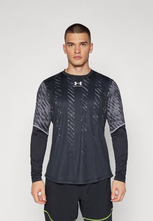 Schwarzes sportliches Langarmshirt mit einem strukturierten Design, das vertikale Streifen und graue Akzente aufweist. Das Material wirkt leicht und enganliegend.