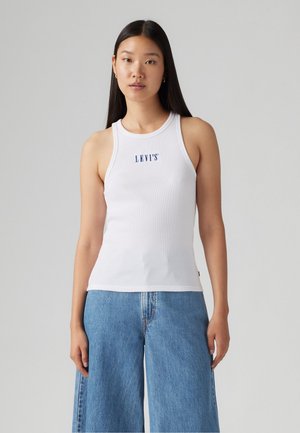 White ribbed tank top with a crew neckline and blue "LEVI'S" logo on the chest, paired with light blue wide-leg jeans.