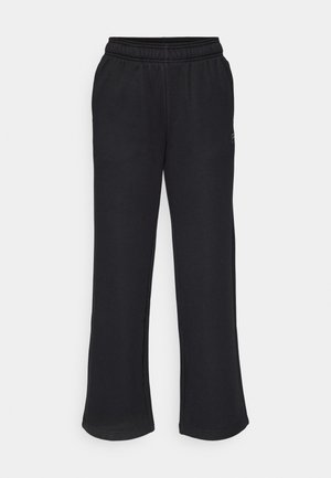 Schwarze Sweatpants mit einem ausgestellten Schnitt, elastischem Bund und seitlichen Taschen. Aus weichem Stoff ohne sichtbare Muster oder Akzente gefertigt.