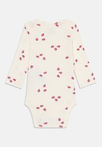Long-sleeve baby bodysuit in cream with scattered pink flower pattern. Soft cotton fabric, round neck, and snap closures at the bottom.