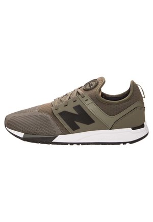 Widok z boku na oliwkowo-zielony i czarny but sportowy New Balance z białą podeszwą i sznurowaniem.