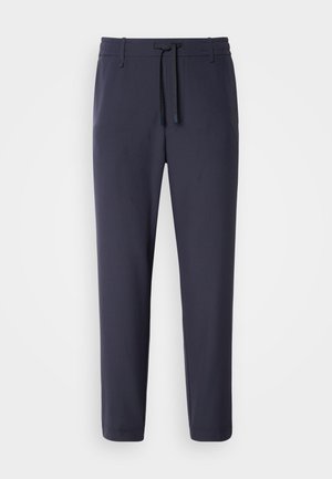 Navy jogger pants with an elastic waistband and drawstring. Made of smooth material, featuring tapered legs and no visible pockets.