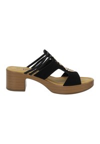 Des sandales noires à semelle glissante avec un carré en bois, des brides courbées et un détail doré. La semelle est rembourrée et texturée pour une meilleure adhérence.