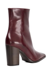 Burgundy leather ankle boot with a pointed toe, smooth texture, and a block heel featuring a wood-like finish.