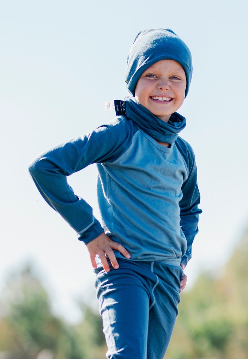 Blue long-sleeve shirt and matching pants, made of soft material. Features a hood and a neck warmer; includes side tag for size or brand.