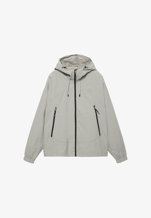 Világosszürke kapucnis dzseki elülső cipzárral, két függőleges cipzáras zsebbel, állítható kapucnis húzózsinórokkal és rugalmas mandzsettákkal.