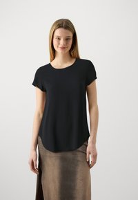 Black short-sleeve shirt with a round neckline and curved hem. Made of soft fabric, designed for a relaxed fit. Features minimal detailing.