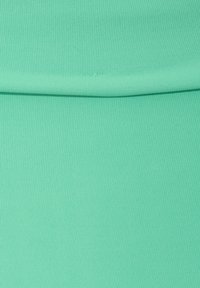 Mint green ribbed fabric with a smooth texture, folded to show the surface pattern and consistent color throughout.