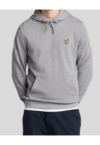 Grå sweatshirt med en framficka, dragskoöverhuvud och en liten gul broderad logotyp på bröstet. Mjuk tyg med en avslappnad passform.