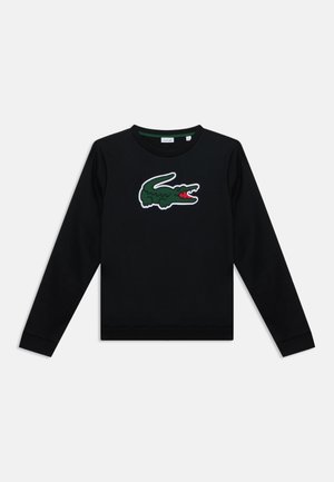 Sweatshirt noir à manches longues avec un grand logo crocodile vert et rouge centré sur la poitrine sur fond blanc.