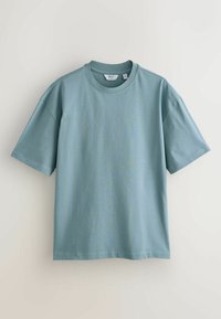 Light blue cotton t-shirt with a crew neckline, short sleeves, and a relaxed fit. Smooth texture with minimal stitching details.