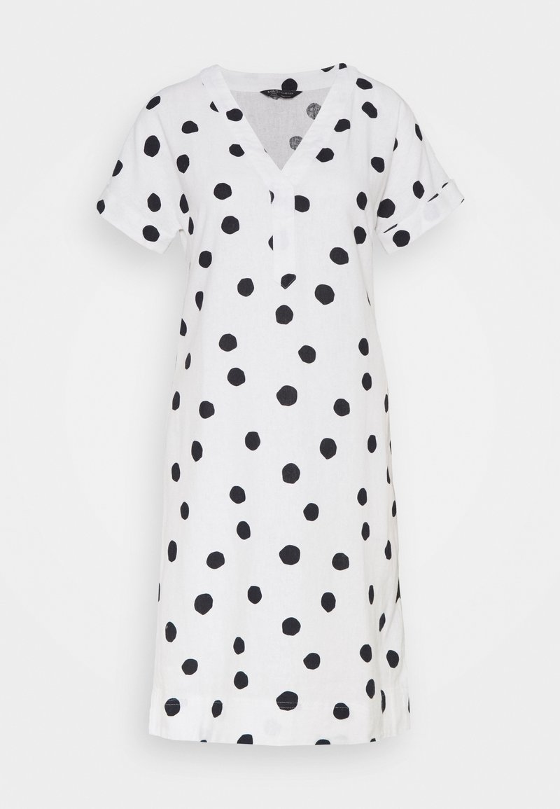 Robe blanche à manches courtes avec pois noirs irréguliers, col en V et coupe décontractée.