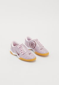 Purple synthetic athletic shoes with a textured upper, pink laces, a visible red '90' detail, and a gum rubber sole.