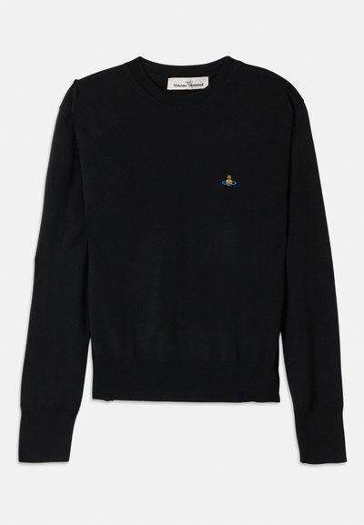 Black knit sweater featuring a round neckline and ribbed cuffs and hem. A small colorful emblem is positioned on the chest.