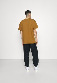 Carhartt WIP AMERICAN SCRIPT PANT - Calças de fato de treino - astro