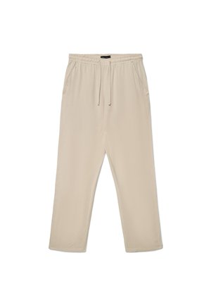 Pantaloni beige con vita elastica, coulisse e tasche laterali, vestibilità dritta e rilassata, mostrati stesi su uno sfondo bianco.
