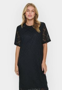 Black lace dress with short sleeves featuring a diamond pattern, round neckline, and a relaxed fit that falls below the knee.