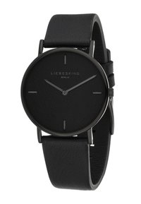 Orologio analogico nero con quadrante rotondo opaco, cinturino in pelle, design minimalista e lancette delle ore e dei minuti argentate. Dettaglio superficie testurizzata.