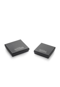Two square black boxes with a smooth matte finish and the text "TRUE REBELS!" in silver on the top surface, one larger than the other.