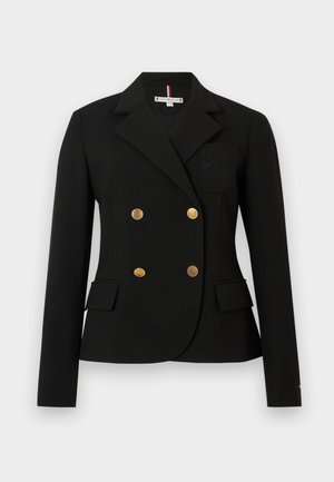 Zwarte blazer met dubbele goudkleurige knopen, metgelapte revers en voorkeurszakken. Heeft een geborduurd embleem op de linkerborst.