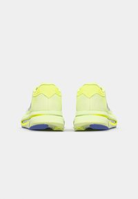 Scarpe da atletica giallo neon con parte superiore in rete, suola ammortizzata e suola in gomma blu. Presentano una texture liscia e un tallone di supporto.